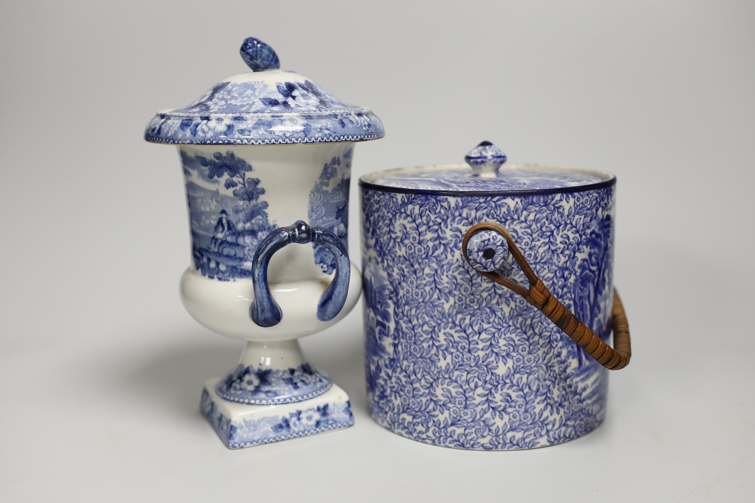 Blue and white pottery- A Victorian Willow pattern comport, a biscuit barrel and an urn with cover